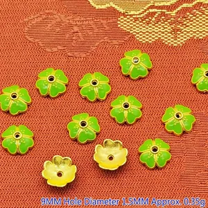 Close-up of 9mm green enamel flower spacer beads for handmade DIY jewelry making