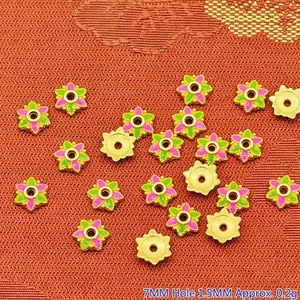 Detailed view of 7mm pink and green enamel flower alloy spacer beads for DIY jewelry making.