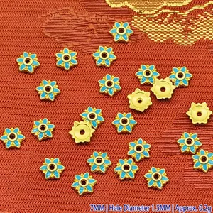 Detail view of 7mm blue enamel flower-shaped alloy bead caps for DIY jewelry making crafts