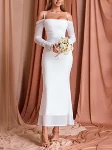 Detailed shot of an elegant white ruched mesh dress featuring off-the-shoulder sleeves