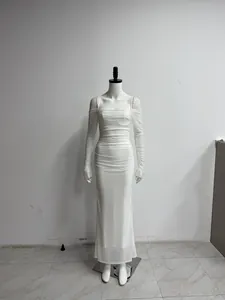 Detailed view of white mesh maxi dress with off-shoulder sleeves and ruched texture