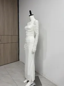 Detail of a white mesh pleated maxi dress with off-the-shoulder long sleeves.
