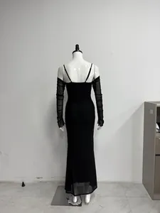 Detailed back view of a sexy black bodycon maxi dress with sheer mesh sleeves on a mannequin