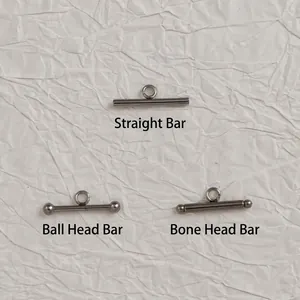 Close-up of three stainless steel OT toggle T-bars in straight, ball, and bone shapes
