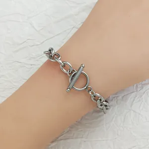 Close-up of a stainless steel toggle clasp on a silver chain bracelet for DIY jewelry.