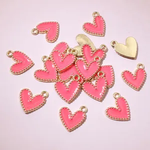 Detailed view of pink enamel heart pendants with gold beaded edges