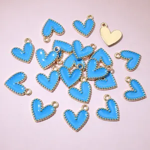 Detailed close-up of light blue heart-shaped enamel charms with gold beaded edges