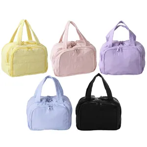 Quilted cotton makeup bags in five macaron colors with dual zippers and handles
