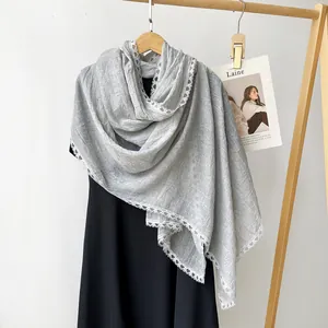 Detailed view of lightweight grey cotton linen scarf with elegant white lace trim