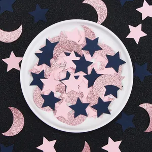 Glittery rose gold moon and navy blue star confetti for birthday party decorations