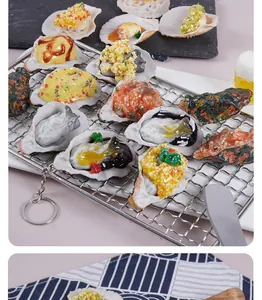 Realistic PVC seafood model keychain detail showing various styles of oysters and scallops.