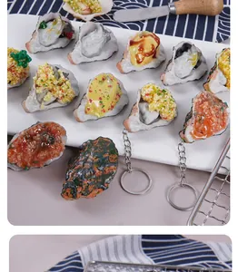Realistic simulated oyster PVC keychain toy models elegantly displayed on a white tray