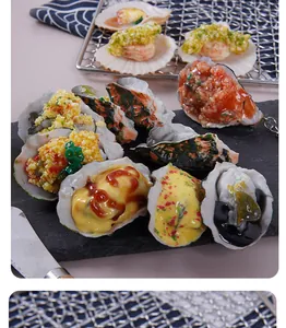 Detailed macro view of realistic PVC simulation oysters and scallops with sauce details.