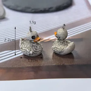 Detail view of resin skeleton duck pendant with 2.2cm height and 1.7cm width dimensions