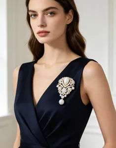 Close-up of a vintage French teardrop pearl and rhinestone brooch on a navy dress