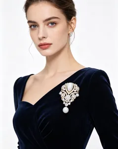 Elegant French vintage water drop pearl brooch with rhinestones worn on a velvet dress