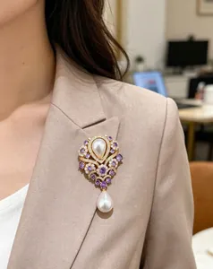 Elegant vintage violet water drop pearl brooch pinned on a stylish beige blazer lapel
