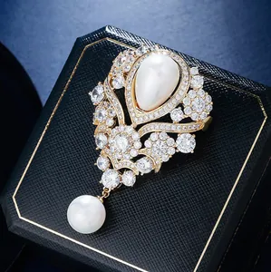 Detailed macro view of an elegant vintage French brooch with water drop pearl and crystals.