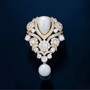Elegant French vintage brooch with teardrop pearls and sparkling crystals in gold setting