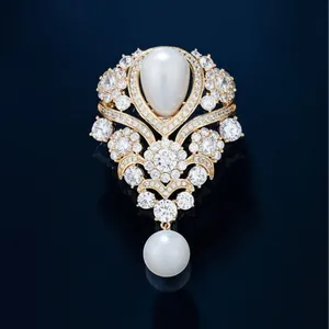 Elegant vintage French brooch with water-drop pearl and sparkling crystals in gold