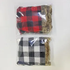 Macro view of Christmas plaid wine bottle covers with brown faux fur trim in packaging