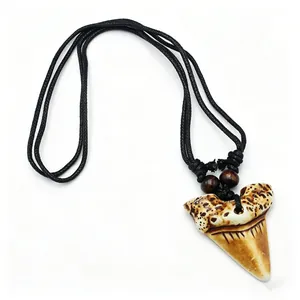 Détail d'un pendentif en résine dent de requin sur cordon noir avec des perles en bois