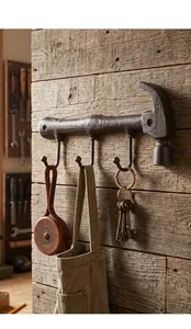 Detailed view of antique cast iron hammer wall hook featuring three hooks for rustic decor