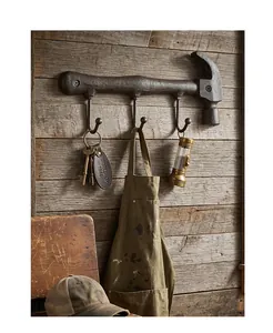 Rustic antique cast iron hammer wall hook featuring three sturdy hanging pegs for tool storage