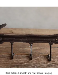 Back view of antique cast iron wall hooks showing stable mounting details