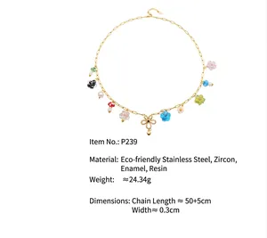 Detail view of colorful charm necklace with mushrooms and flowers on gold chain