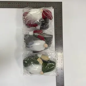 Detailed view of three plush Christmas gnomes set in plastic bags with ruler measurement