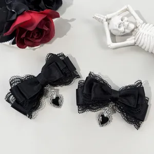 Close-up detail of black gothic lace bow hair clips featuring ornate silver heart charms