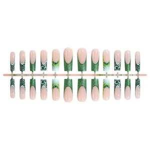 Emerald green glitter French press-on nails set with rhinestone accents and wavy patterns