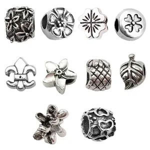 Set of antique silver alloy large hole beads featuring heart, clover, and flower designs.