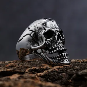 Close-up of a polished vintage stainless steel skull ring with realistic cracked details.