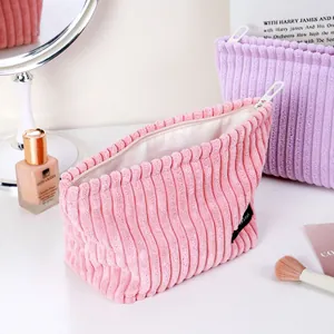 Soft pink corduroy cosmetic makeup bag with a high-quality textured finish for travel