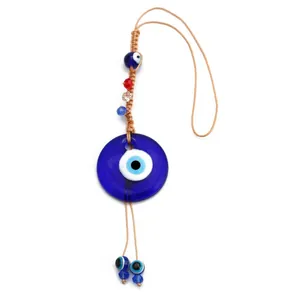 Traditional Turkish Evil Eye hanging ornament featuring blue glass pendant and woven cord