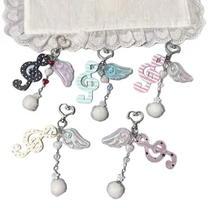 Porte-clés créatifs en forme de note de musique avec ailes d'ange irisées et pompons blancs