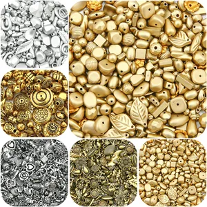 Detailed view of vintage gold and silver assorted beads for DIY jewelry making.