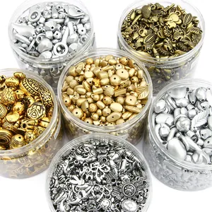 Collection of various metal alloy DIY jewelry beads in transparent storage jars