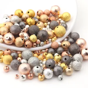 Macro view of assorted 3-12mm frosted metallic copper beads for DIY jewelry making.