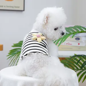 Detail view of a cute black and white striped pet vest with a flower on a small dog