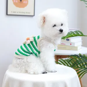 Close-up of green and white striped pet knit vest featuring a cute flower decoration