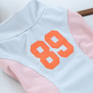 Close-up of pet vest fabric featuring breathable mesh and orange number 89 print