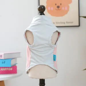 Close-up of breathable grey mesh and pink fabric detail on small pet vest on mannequin
