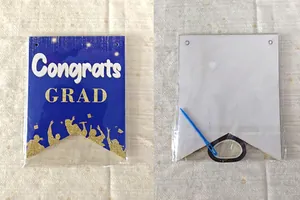 Blue graduation banner detail with Congrats GRAD text and golden glitter silhouettes.