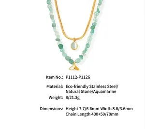 Detail view of double-layer necklace with green stone beads and whale tail pendant