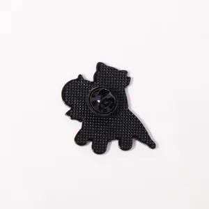 Back view of cartoon dinosaur enamel pin showing butterfly clutch and textured finish
