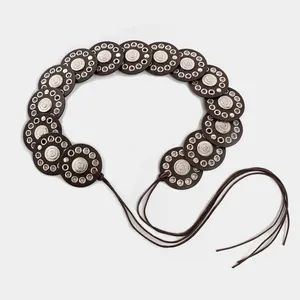 Vintage ethnic style wide belt with hollow metal eyelets and decorative concho details