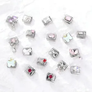 Close-up of various DIY modular charms with colorful rhinestones and motifs